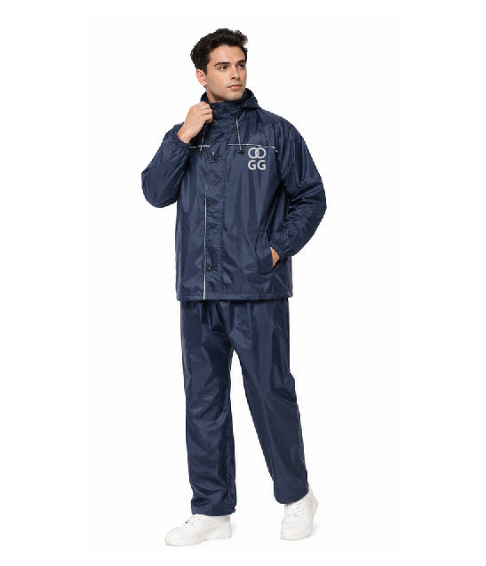 Man wearing a navy raincoat and pants with a logo on a white background