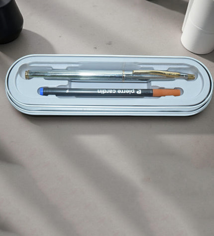 Two pens in a transparent case on a textured surface