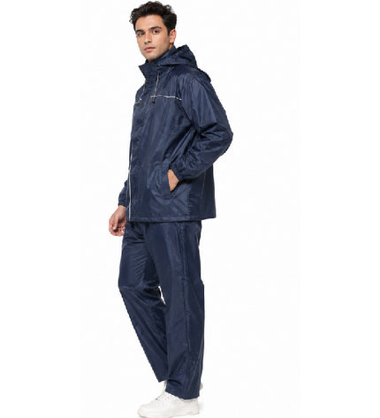 Man wearing a navy raincoat and pants on a white background