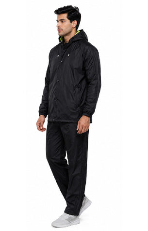 Man wearing a black raincoat and pants on a white background