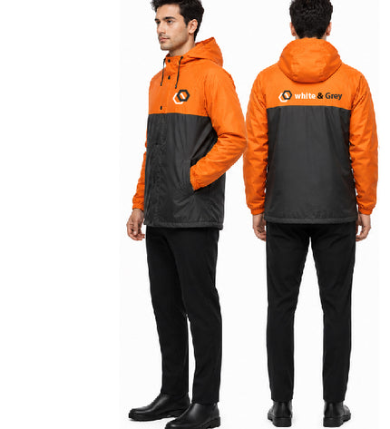 Orange and black raincoat with 'White & Grey' logo worn by a person on a white background