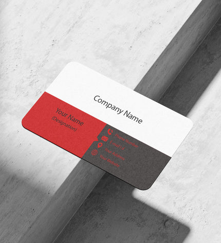 Business card with red and black design on a gray surface