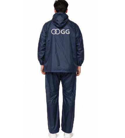 Person wearing a navy raincoat and pants with 'OGG' logo on the back, on a white background