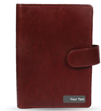 Maroon leather planner with a strap on a white background