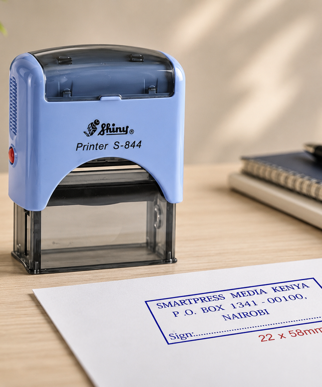Blue stamp on a desk with a printed stamp impression on paper