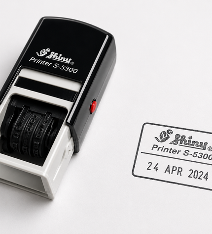 Shiny self-inking stamp with ink cartridge on a white background