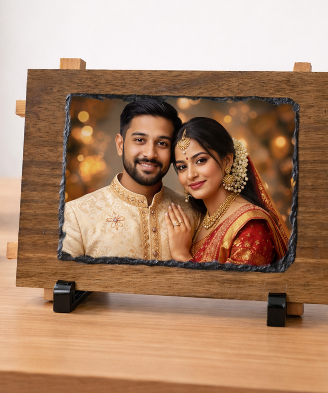 Wooden photo frame with a couple's portrait on a desk with a plant and cup in the background