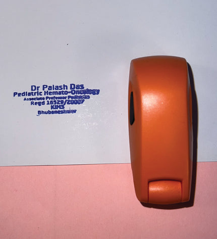 Red wheel with a blue stamp on a white and pink background