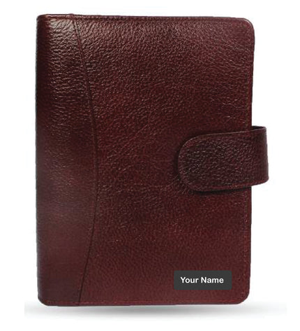 Maroon leather planner with a strap on a white background