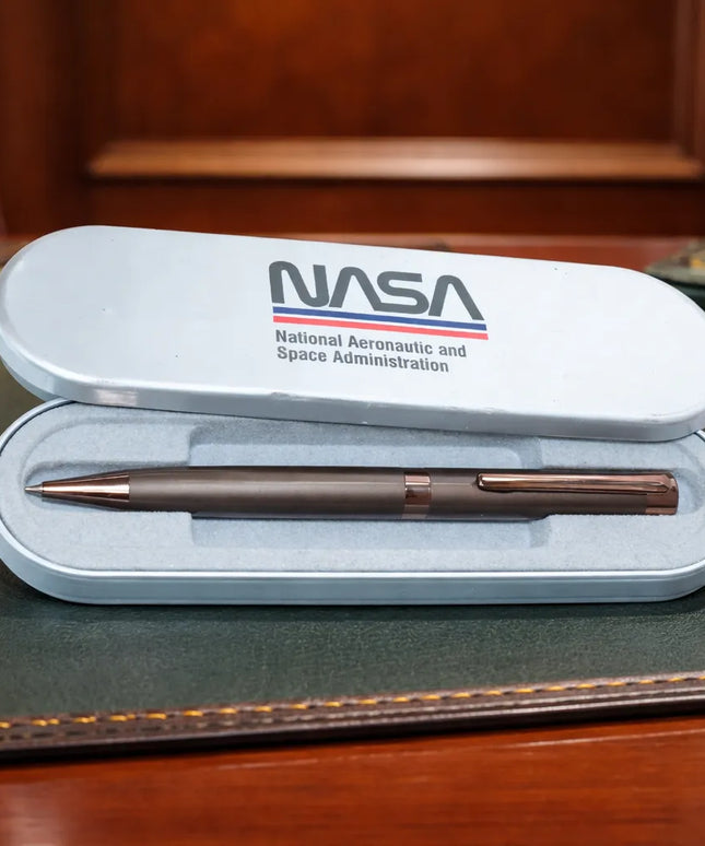 NASA pen set on a desk with an American flag in the background