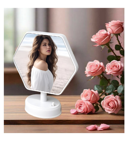 Hexagonal vanity mirror on a wooden surface with pink roses