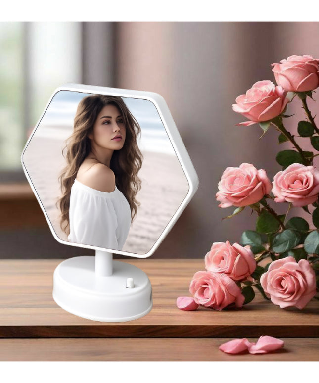 Hexagonal vanity mirror on a wooden surface with pink roses